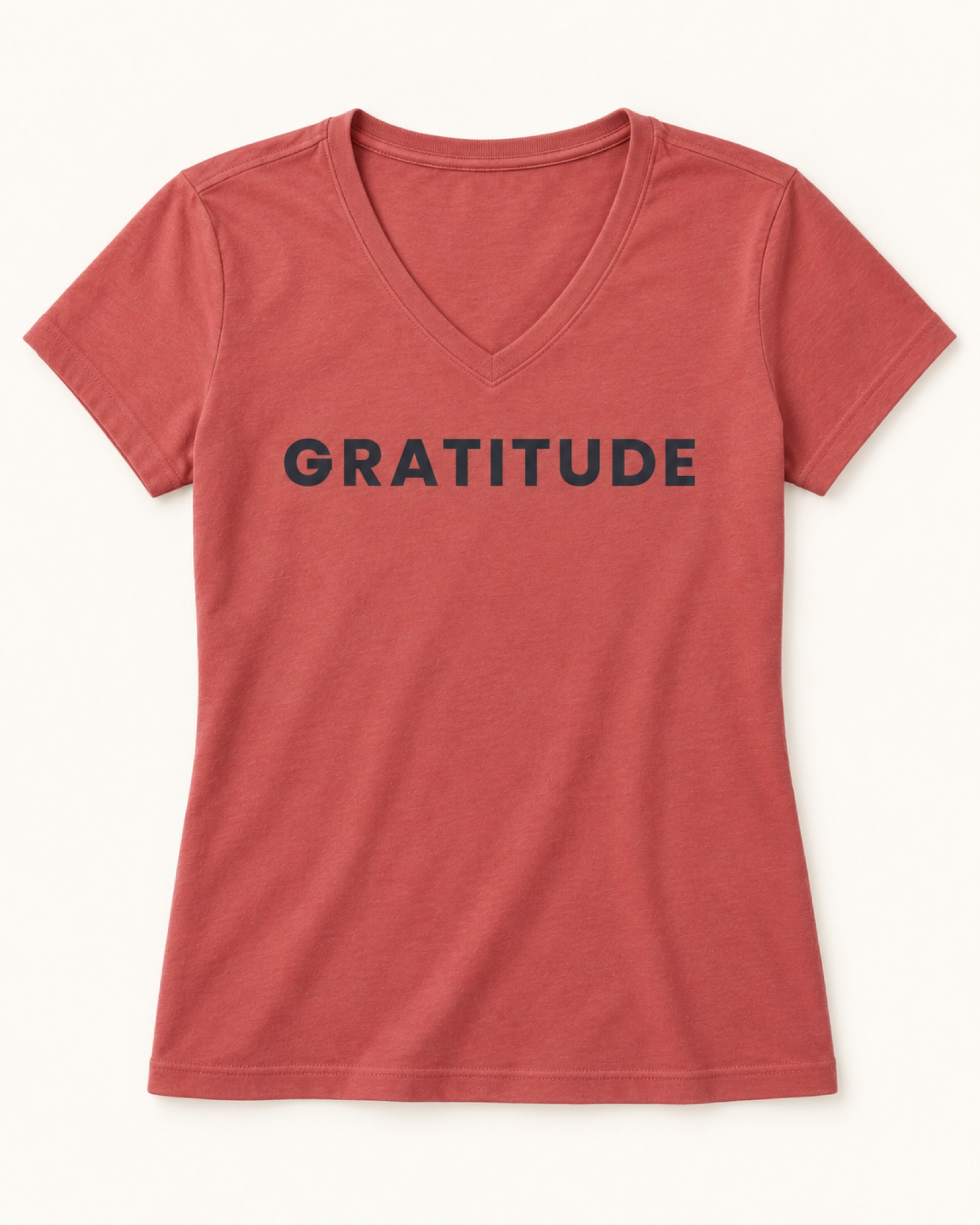 Gratitude printed on a coral V-neck tee — styling sample, not a product variant