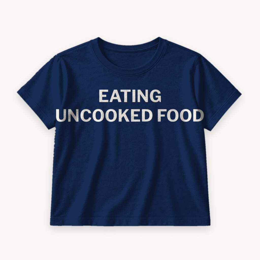 Eating Uncooked Food printed on a Navy tee — product photography